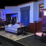 room with blue walls, purple clock, staircase, and sofa - set for mousetrap